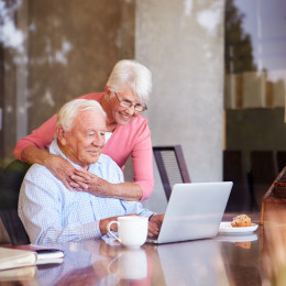 Happy couple looking at computer