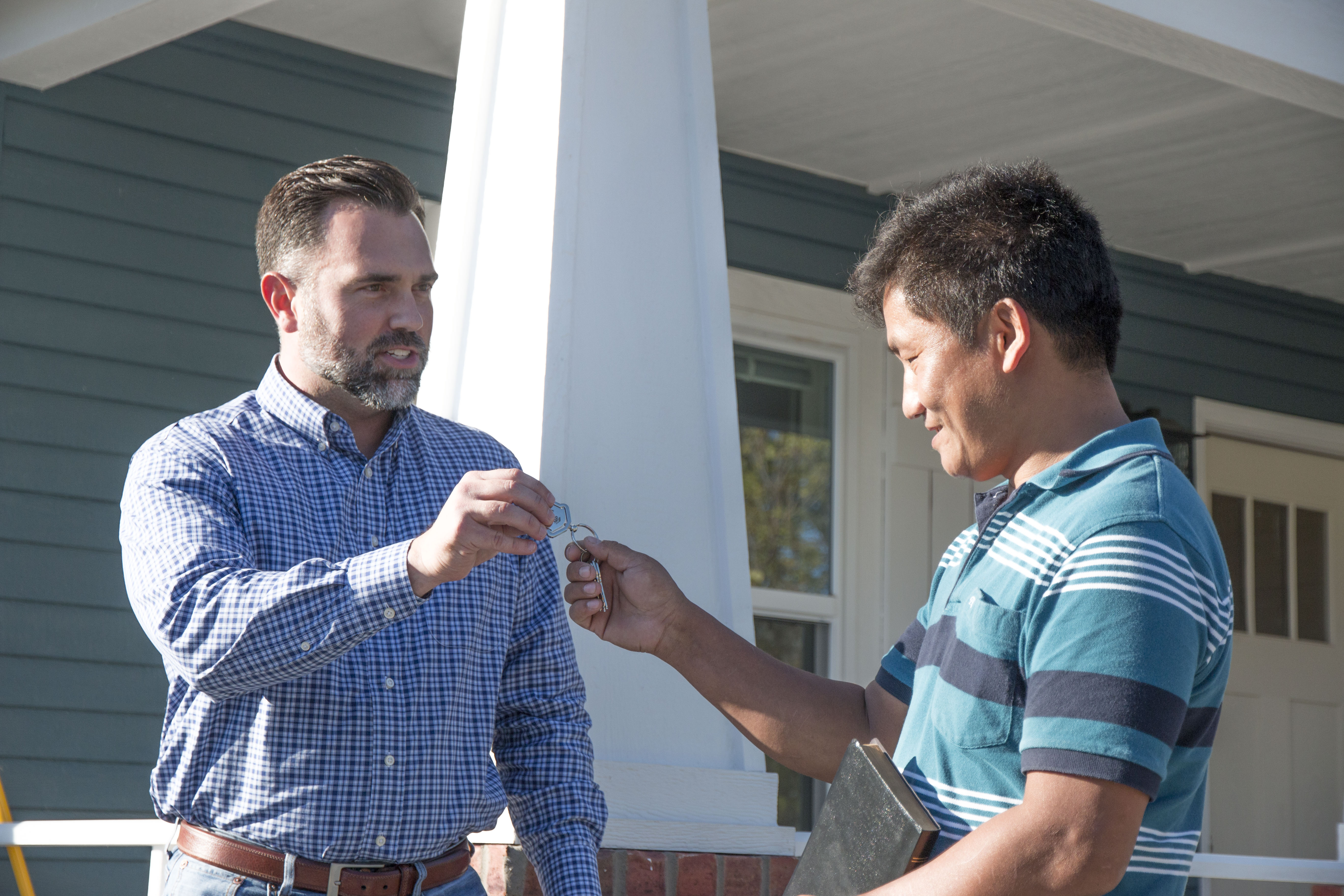 Cameron Walker handing house keys to client