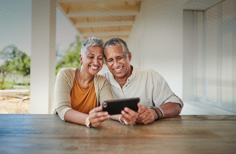 older diverse couple looking at a phone