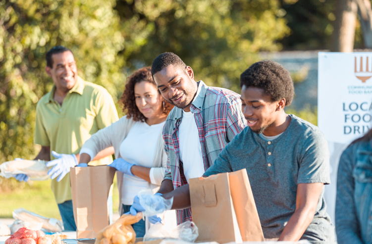 people volunteering by packing food